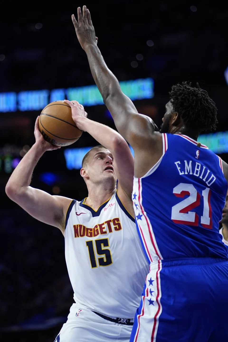 Denver Nuggets' Nikola Jokic, left, goes up for a shot against Philadelphia 76ers' Joel Embiid during the first half of an NBA basketball game, Tuesday, Jan. 16, 2024, in Philadelphia. (AP Photo/Matt Slocum)