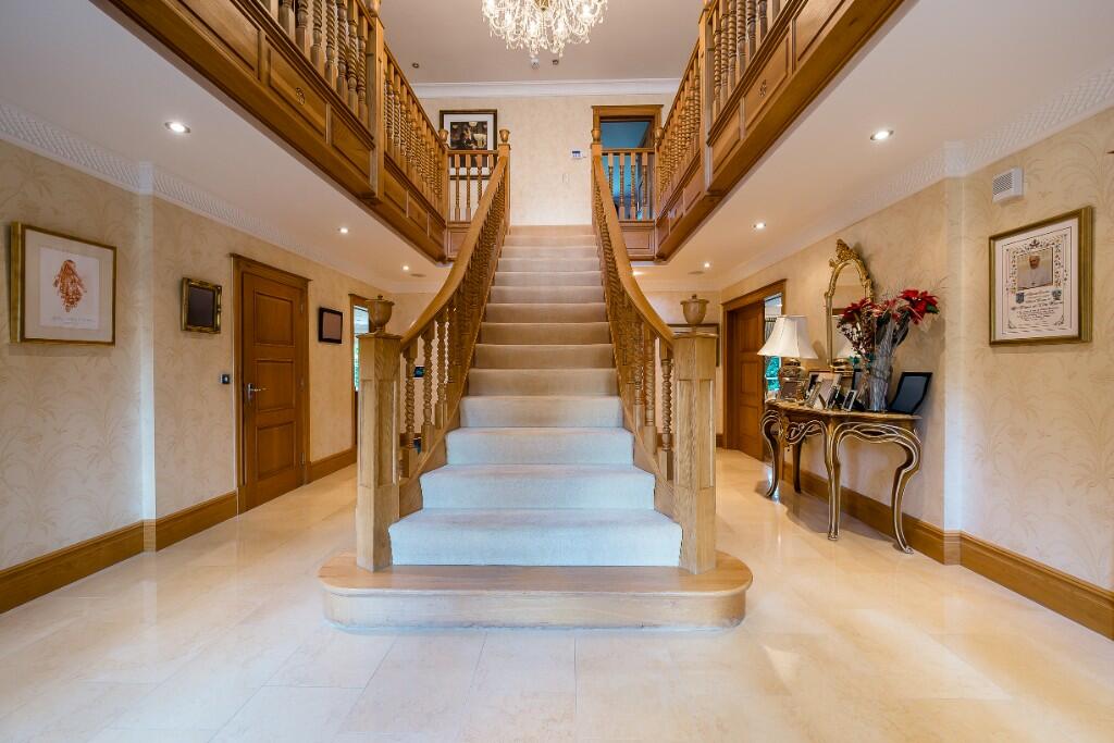 The eye-catching home has a chandelier dangling in the hallway