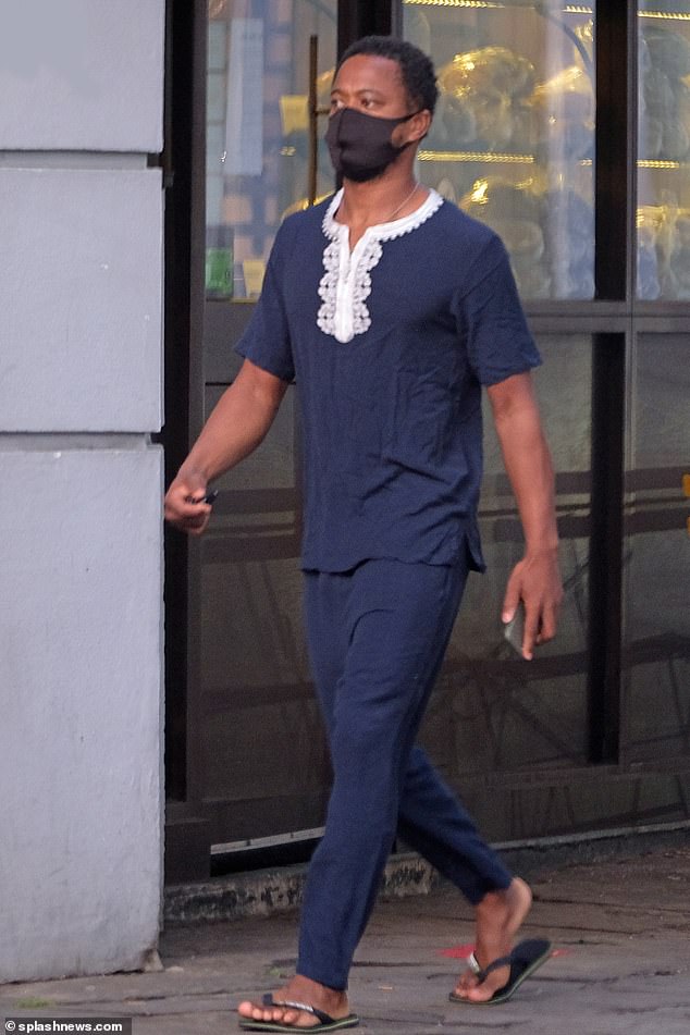 Strolling: Patrice was later seen walking without his model girlfriend