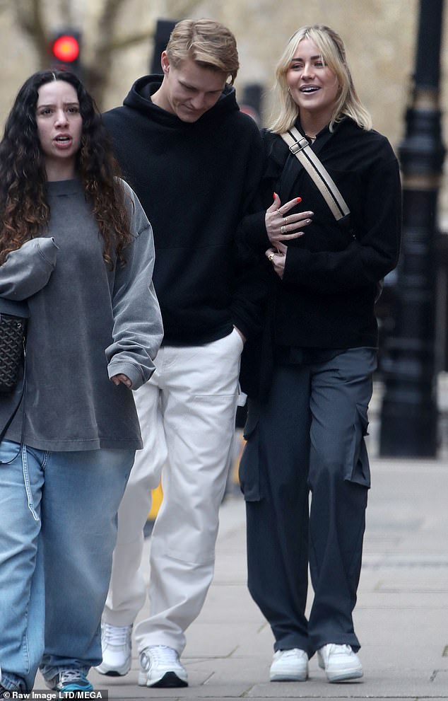 Outfit: Martin looked casual in a black hoodie and white trousers while completing his look with comfortable trainers