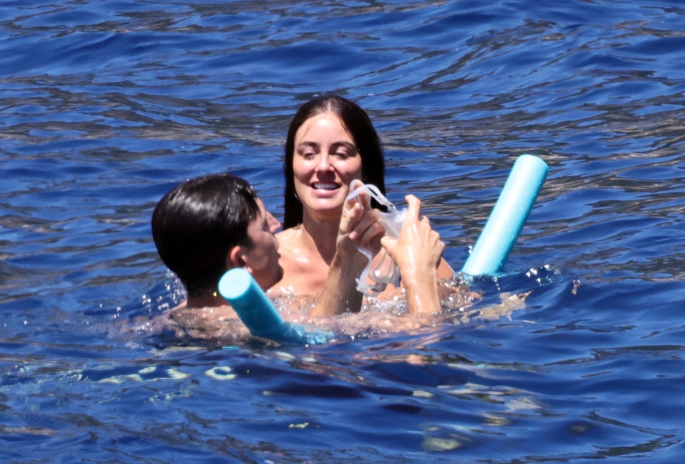 The newlyweds then had a playful swim together