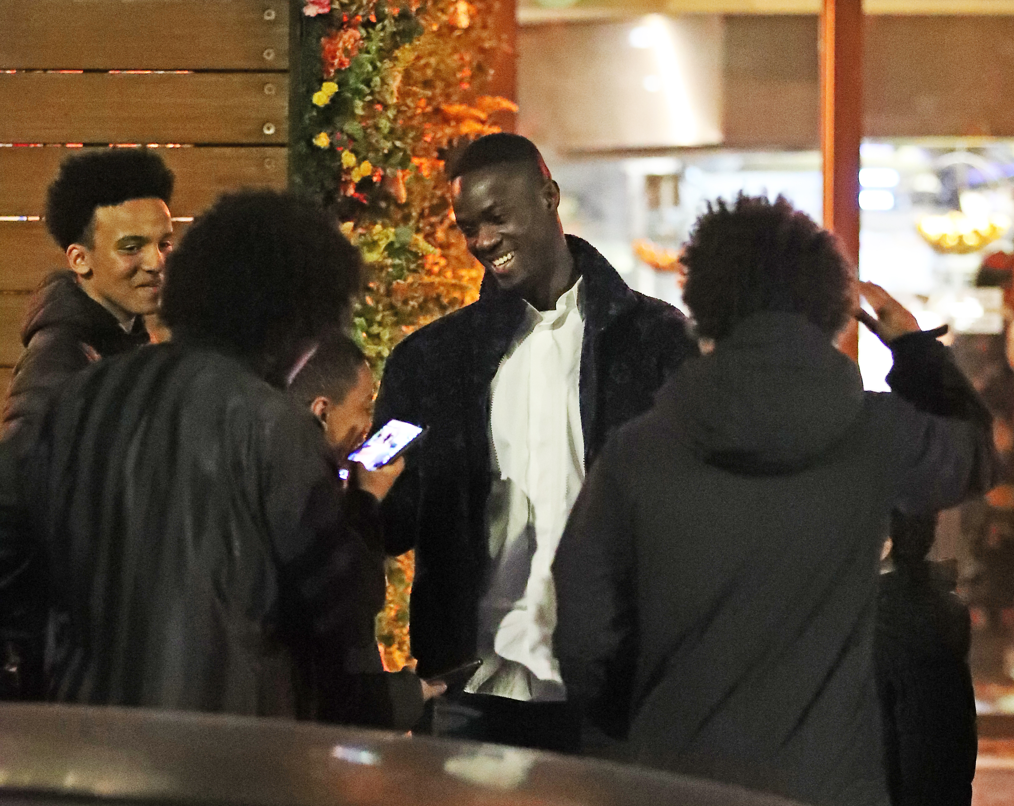 Eric Bailly was greeted by a group of teenagers as he left the restaurant