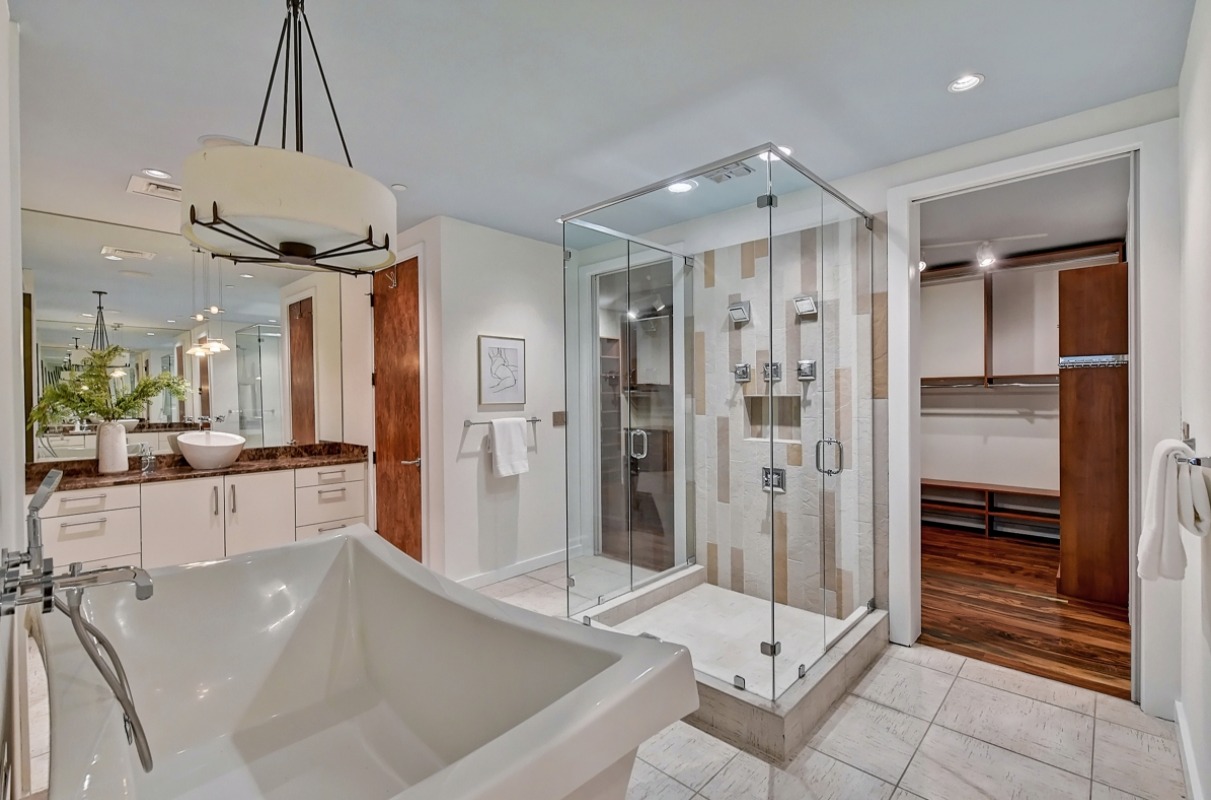 The master bedroom has an enormous bathroom with a huge soaking tub. The unit also includes a walk-in closet