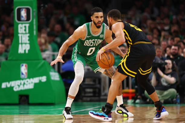 Jayson Tatum of the Boston Celtics defends Stephen Curry of the Golden State Warriors during the second quarter at TD Garden on March 03, 2024 in...