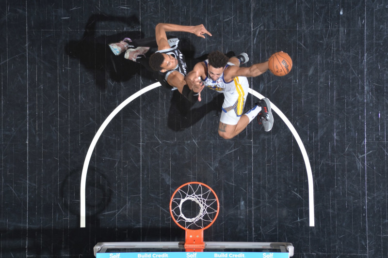 SAN ANTONIO, TX - MARCH 11: Trayce Jackson-Davis #32 of the Golden State Warriors drives to the basket during the game as Victor Wembanyama #1 of the San Antonio Spurs plays defense on March 11, 2024 at the Frost Bank Center in San Antonio, Texas. NOTE TO USER: User expressly acknowledges and agrees that, by downloading and or using this photograph, user is consenting to the terms and conditions of the Getty Images License Agreement. Mandatory Copyright Notice: Copyright 2024 NBAE (Photos by Michael Gonzales/NBAE via Getty Images)