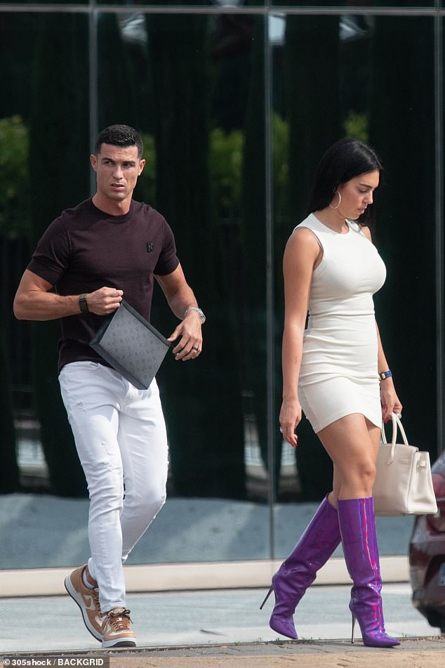 Walk this way: The model, 29, slipped into a cream mini dress teamed with racy, knee-high purple boots as she strolled alongside her footballer beau, 38, in the Spanish capital