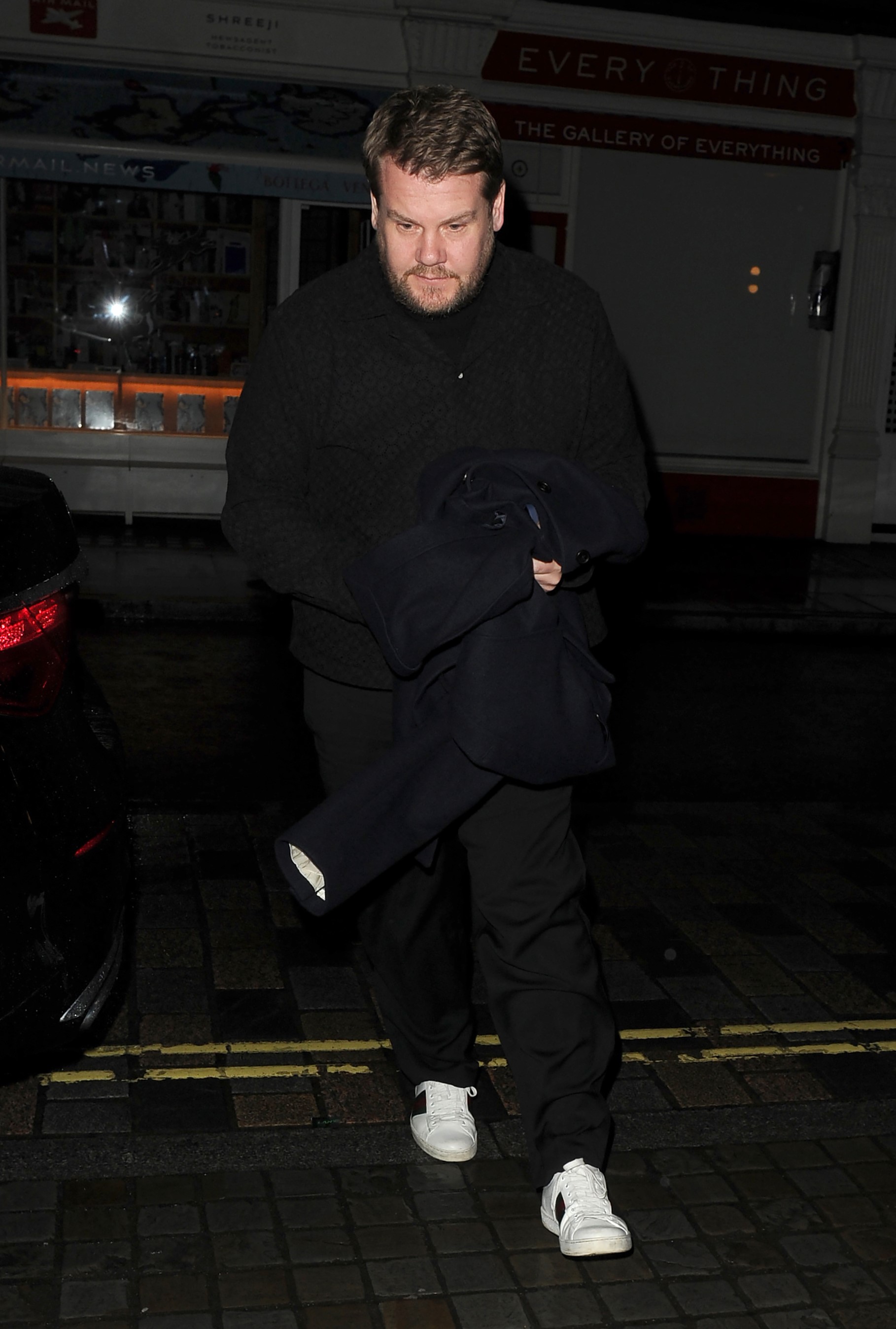 Corden wore white trainers with his black look