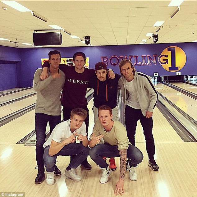 Just weeks after signing his first professional contract, Odegaard broke more records by becoming the youngest player to score in the league. Here he is pictured bottom left bowling with friends