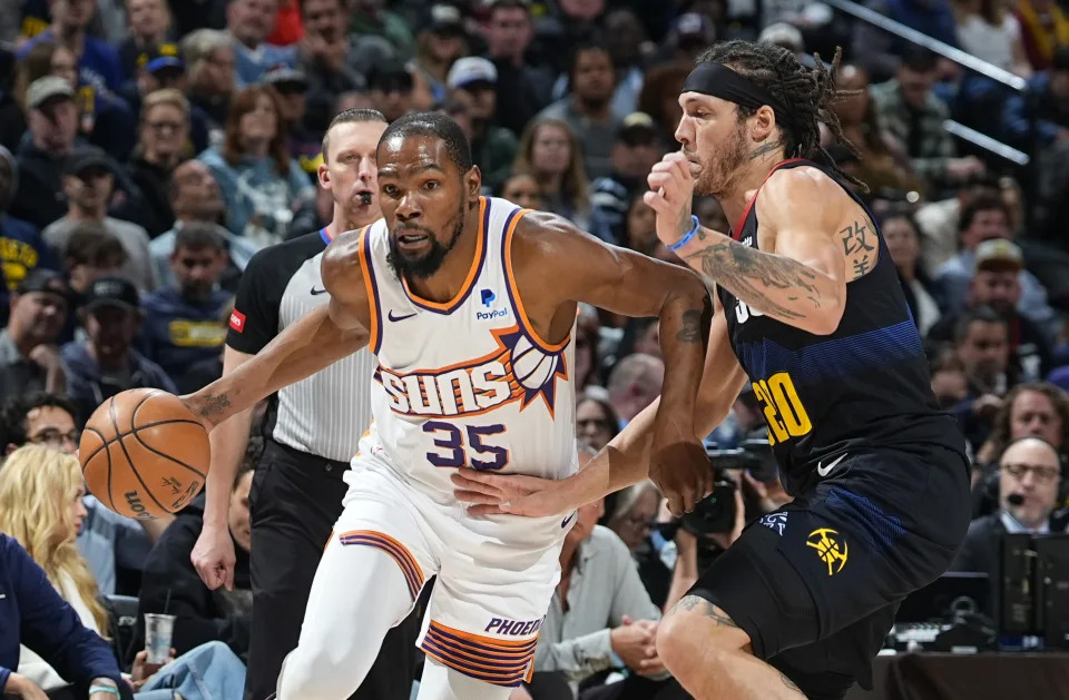 Phoenix Suns forward Kevin Durant drives past Denver Nuggets forward Aaron Gordon during the first half of an NBA basketball game Wednesday, March 27, 2024, in Denver. (AP Photo/David Zalubowski)