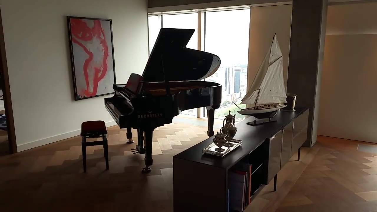  A grand piano sits in a reception room