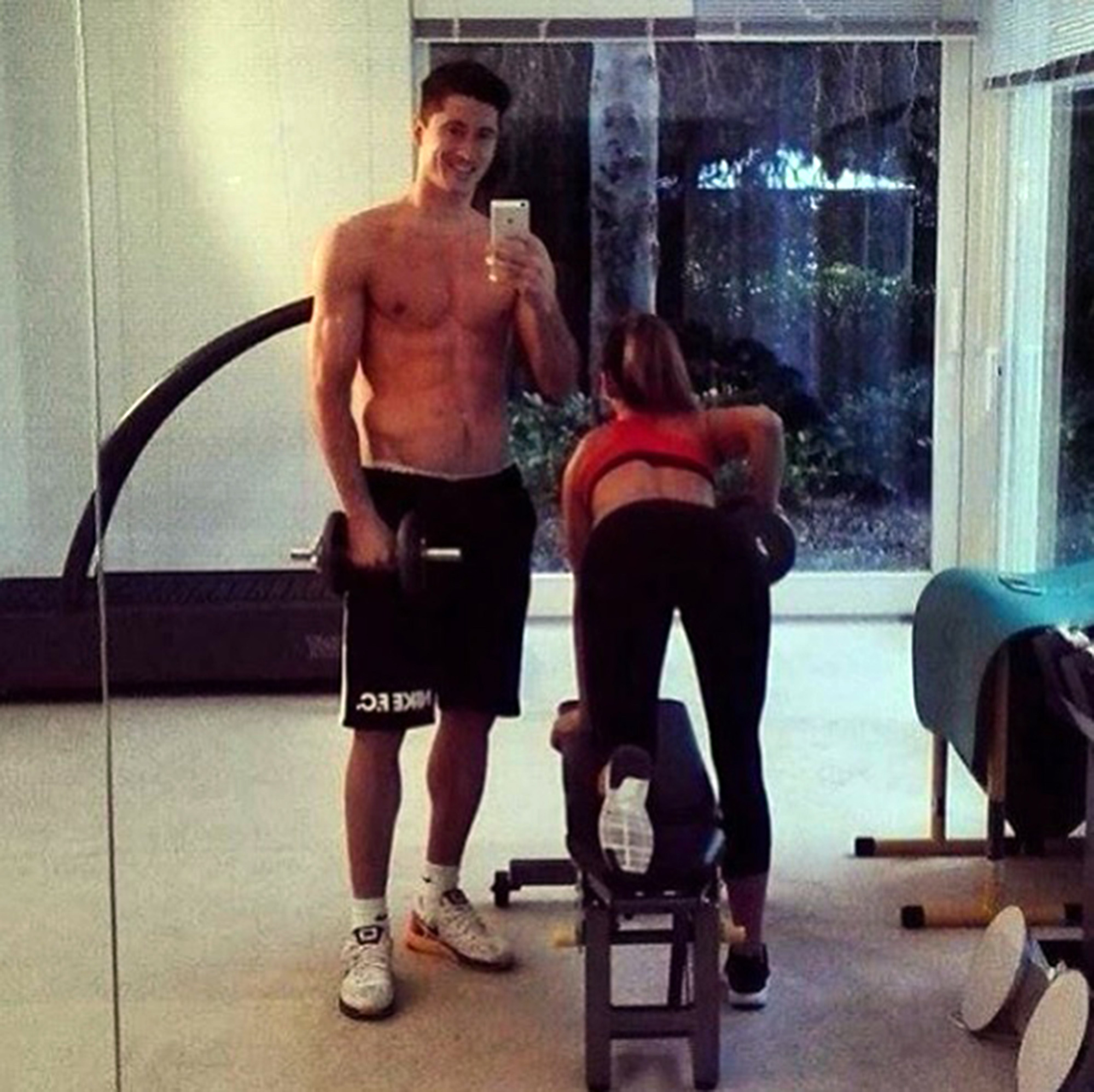  Robert Lewandowski takes a cheeky picture of and wife Anna as they work out together