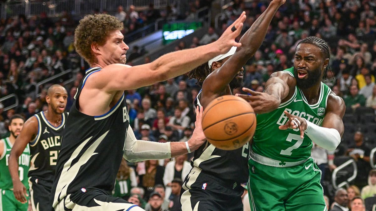 Boston Celtics forward Jaylen Brown (7) gets a pass away from Milwaukee Bucks center Brook Lopez (11) in the third quarter at Fiserv Forum