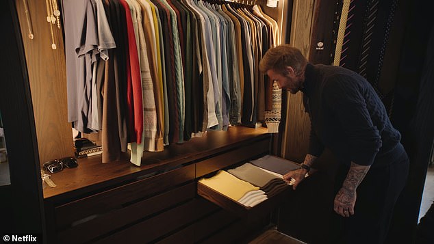 Neat: David showed off his immaculately organised wardrobe as he spoke about his 'obsession' with keeping things in order