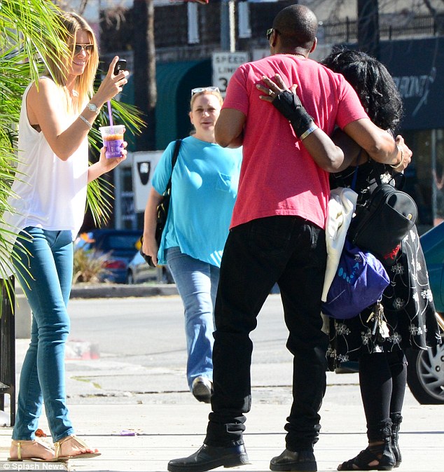 Stopping for a snap: The Shrek star stopped for a photo with a fan as his girlfriend took the picture