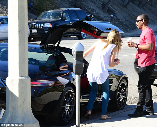 Sweet ride: The pair headed out in their $300,000 black Mercedes-Benz SLS AMG