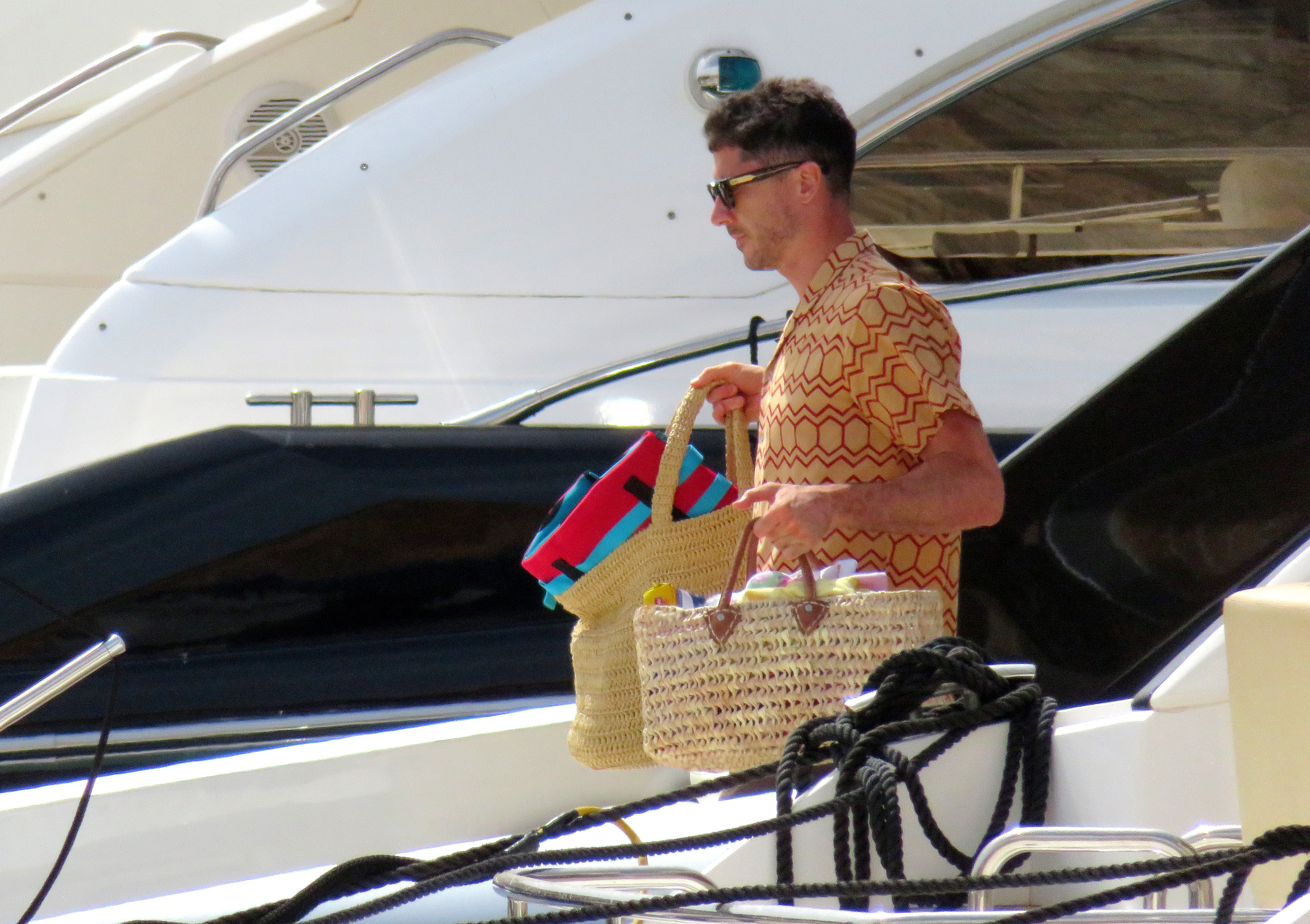 Robert Lewandowski has been spotted carrying bags of beach supplies on a yacht in Majorca