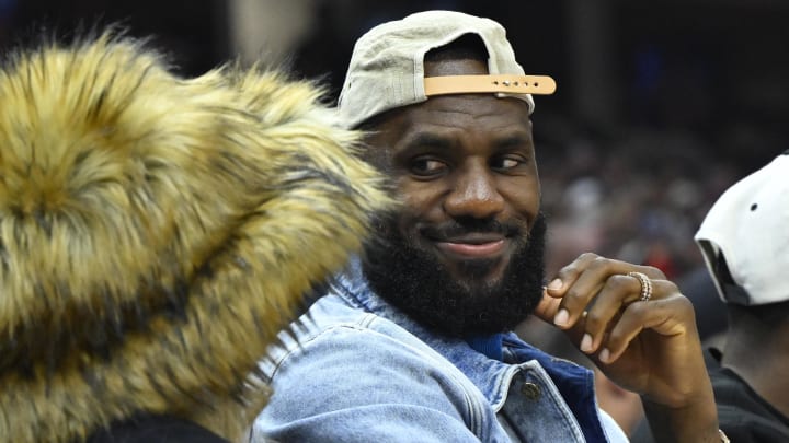 Los Angeles Lakers forward LeBron James looks at his wife Savannah while seated courtside at Rocket Mortgage FieldHouse. 