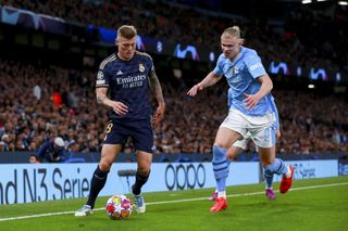 Real Madrid midfielder Toni Kroos in action against Manchester City and Erling Haaland in the Champions League in April 2024.