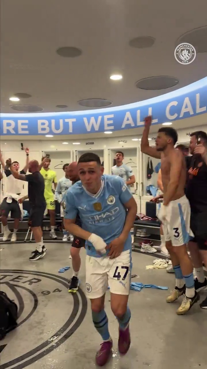 Phil Foden hid for cover as booze and water were sprayed in the air