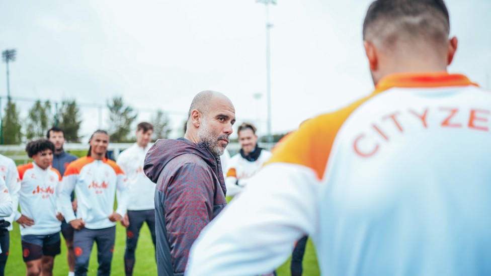 FOCUS AGAIN : Pep Guardiola speaks to his players at the start of the session