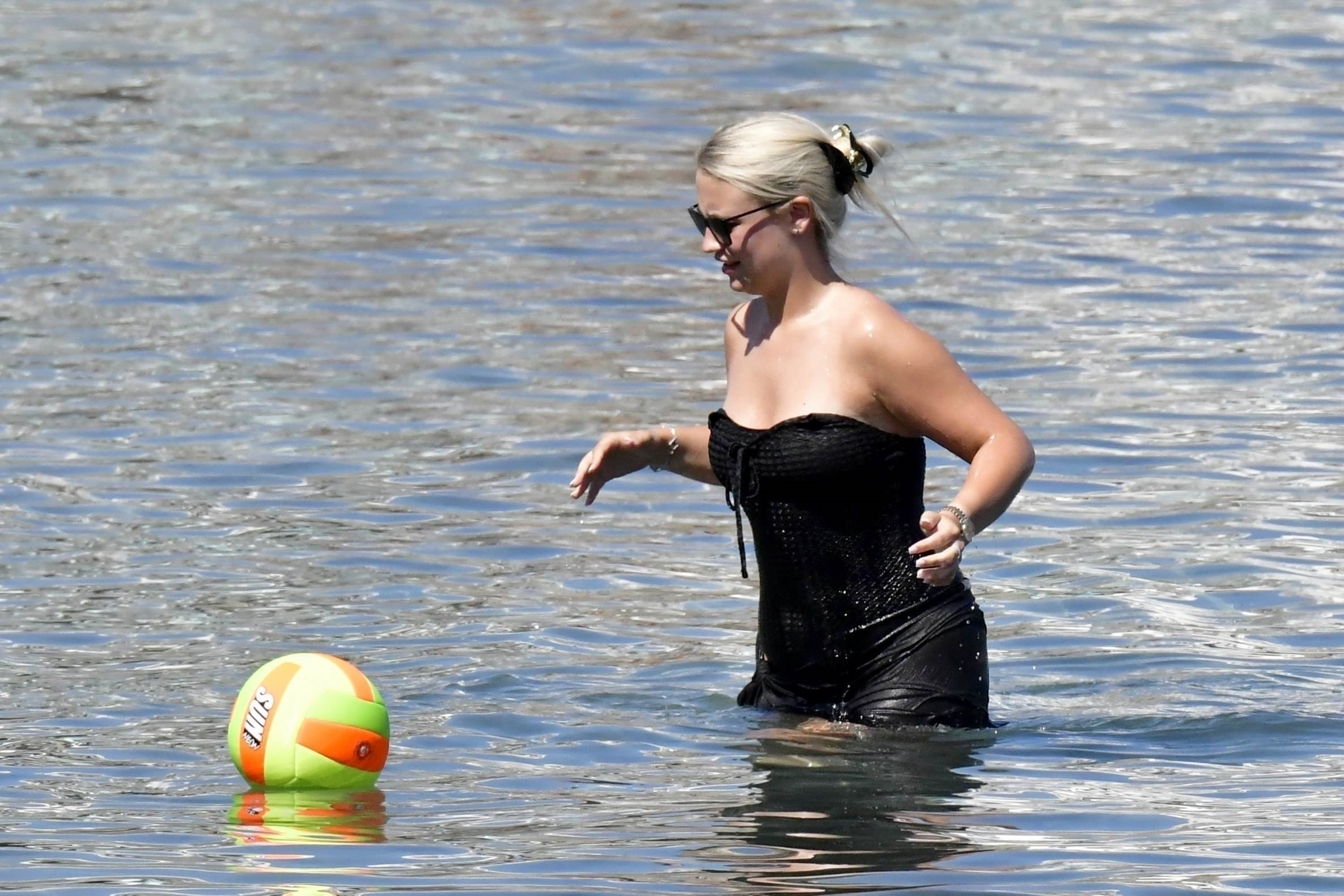 Rebecca, 22, took a dip in the sea wearing a strapless black swimsuit