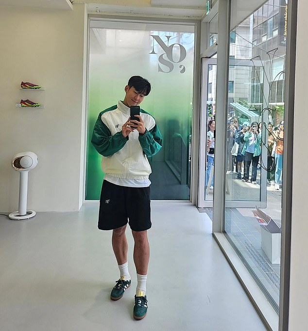 Son posted another picture of himself inside the shop, with a large crowd of fans waiting for him (right) outside