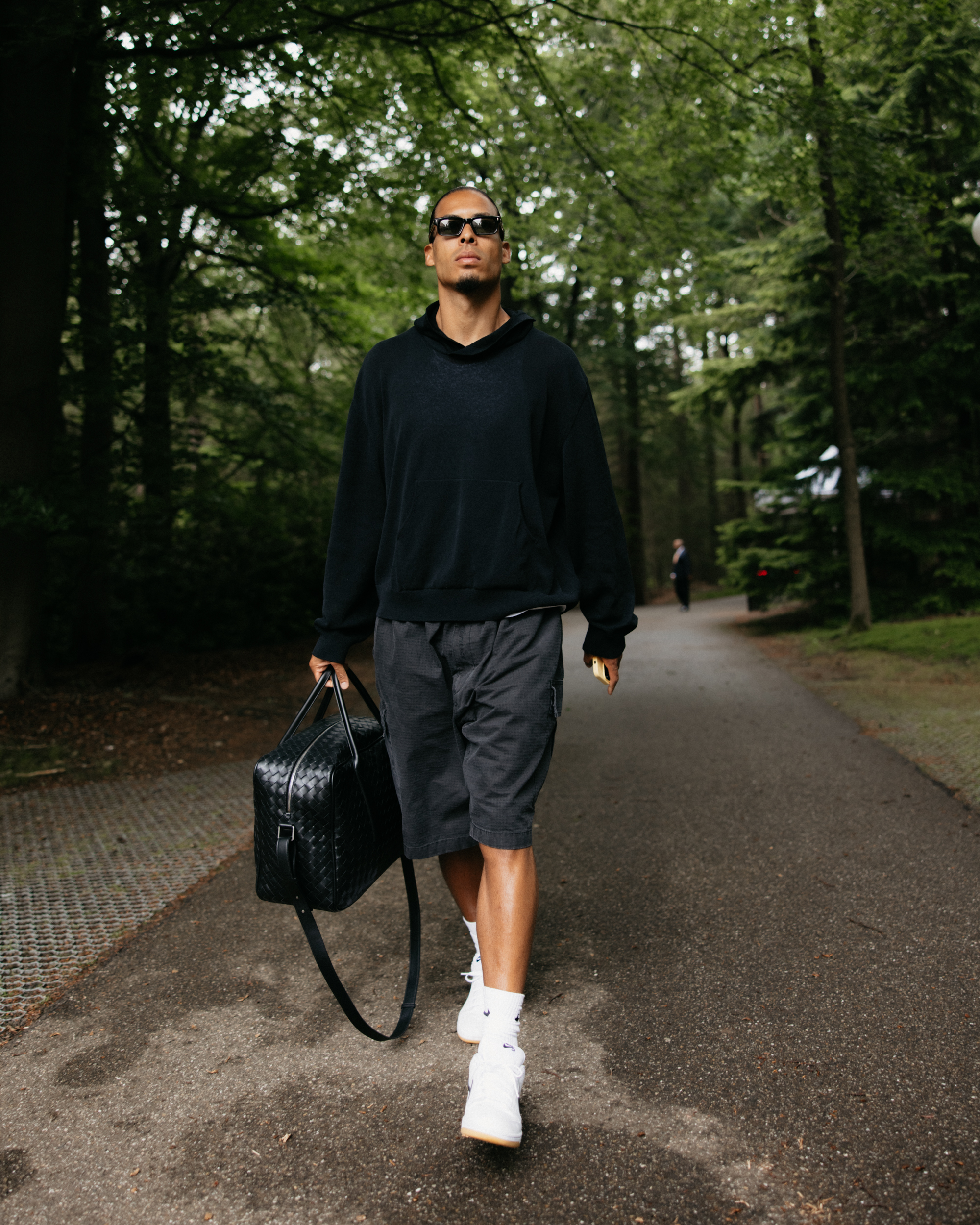Virgil van Dijk wearing sunglasses and carrying a bag as he walks into training for the Dutch National team