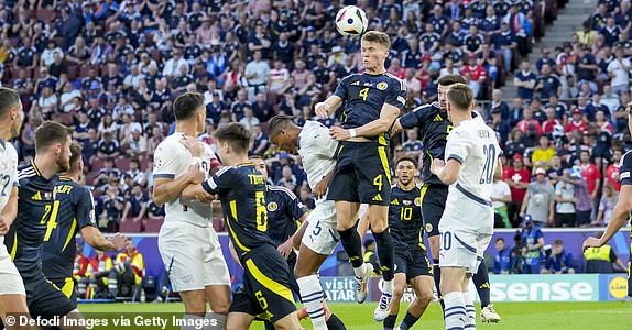 COLOGNE, GERMANY - JUNE 19: Manuel Akanji of Switzerland and Scott McTominay of Scotland battle for the ball during the UEFA EURO 2024 group stage match between Scotland and Switzerland at Cologne Stadium on June 19, 2024 in Cologne, Germany. (Photo by Alex Gottschalk/DeFodi Images via Getty Images)