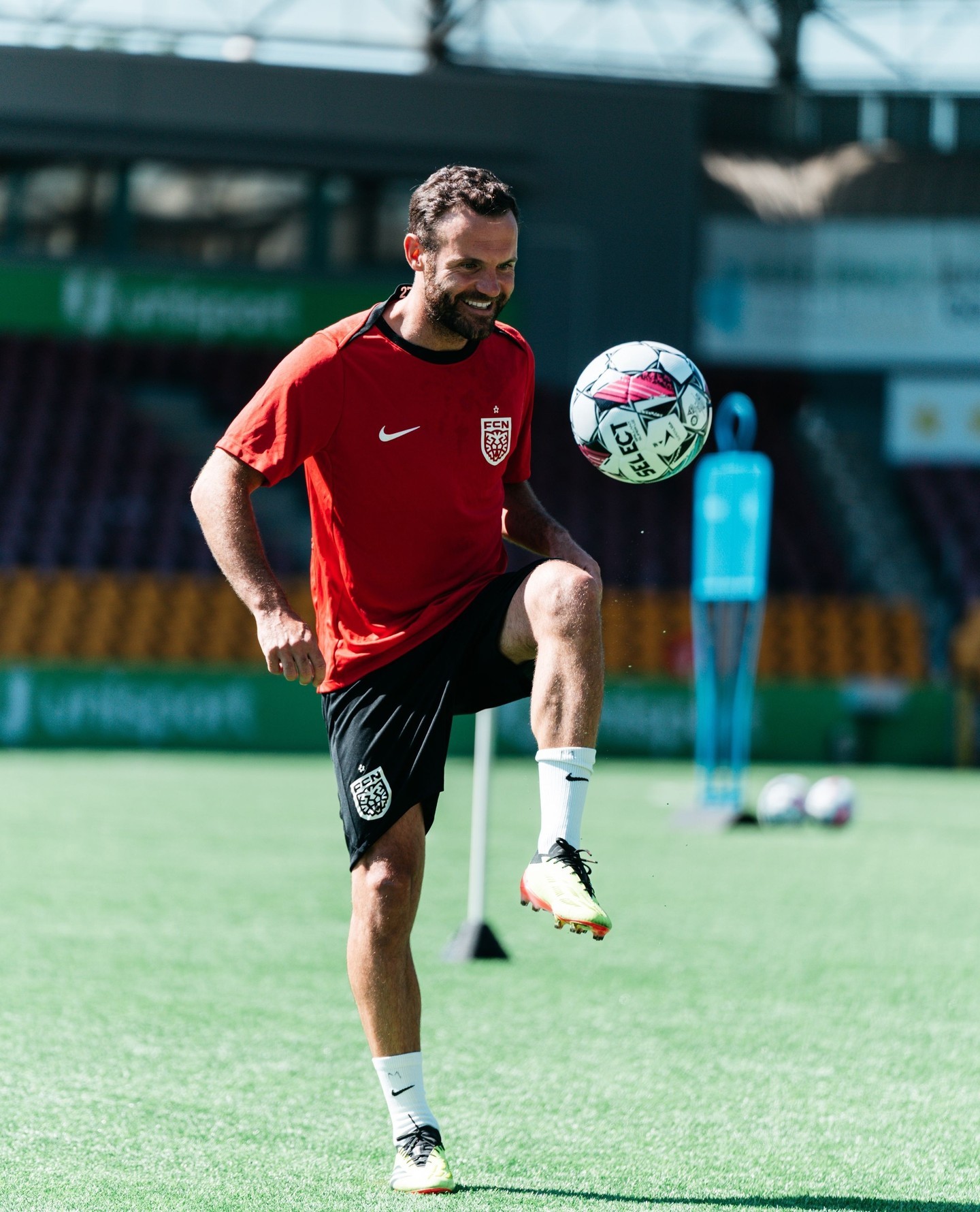 Juan Mata looks delighted to be back on the grass