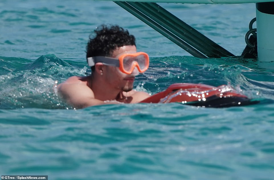 Just keep swimming! Curtis donned a pair of large goggles for his dip in the ocean