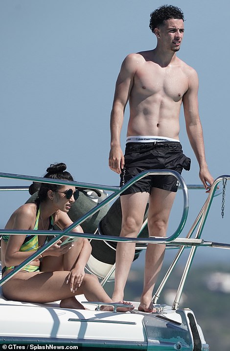 Sun seekers! The couple sat on the front of the boat while moored near Formentera