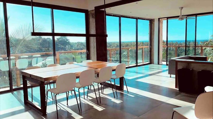 The dining room offers vast views through floor-to-ceiling windows.