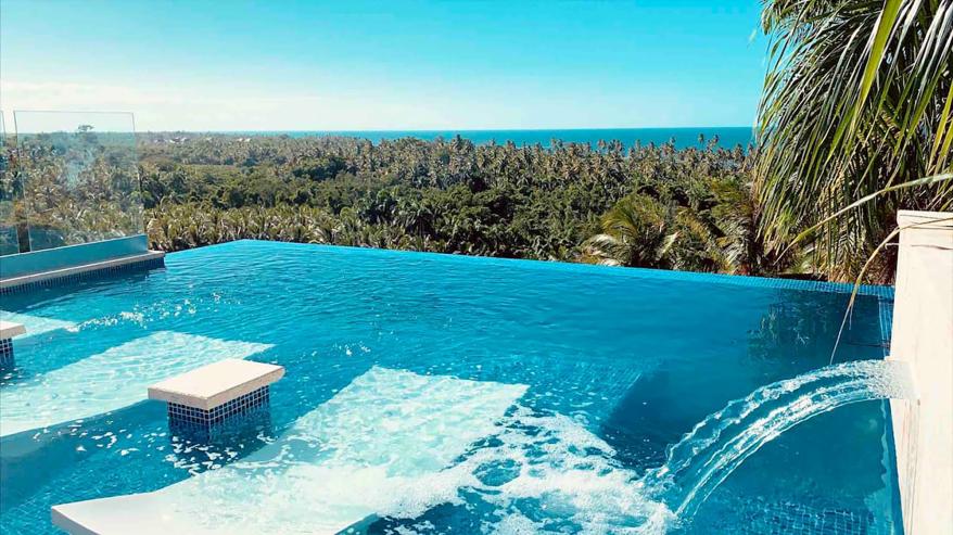 The infinity pool has fountain water features.