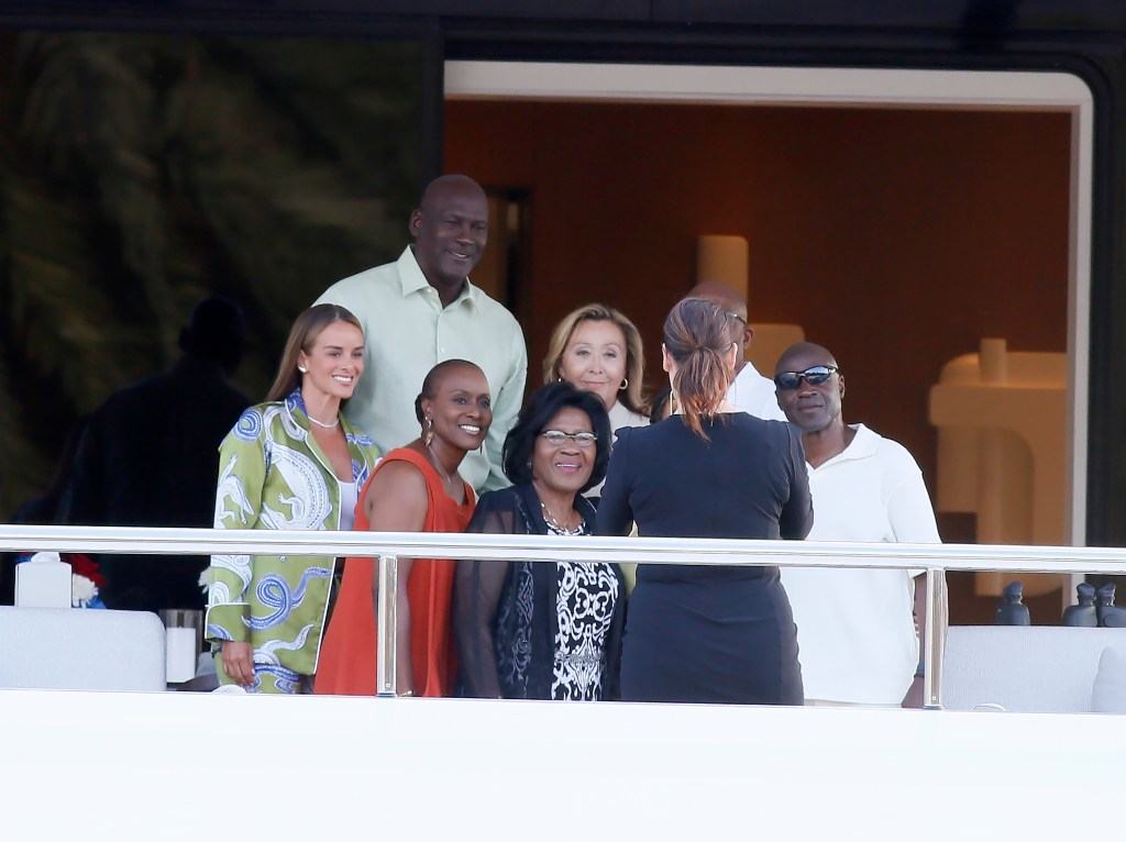 Yvette Prieto and Michael Jordan take a photo with his mom Deloris (bottom left), brothers James Jr (second from right) and Larry (right) and sister Roslyn (third from left) while on his yacht in Barcelona. 