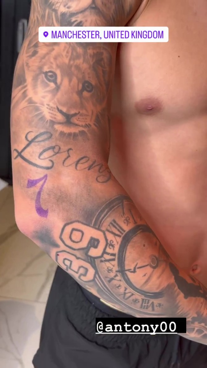 Antony has a lion and a clock face on one of his arms