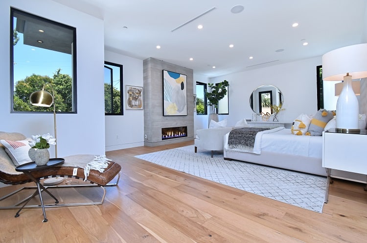 large bedroom with fireplace and seating area