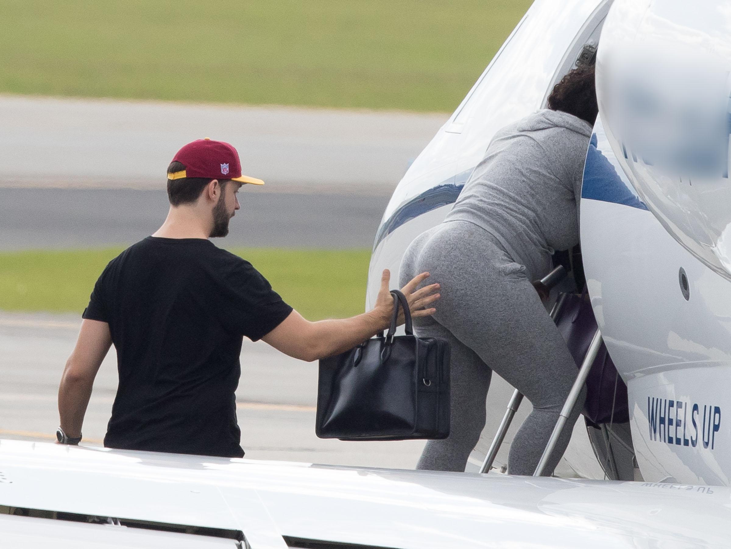  He appeared to be reaching out to give her a pat on the bum