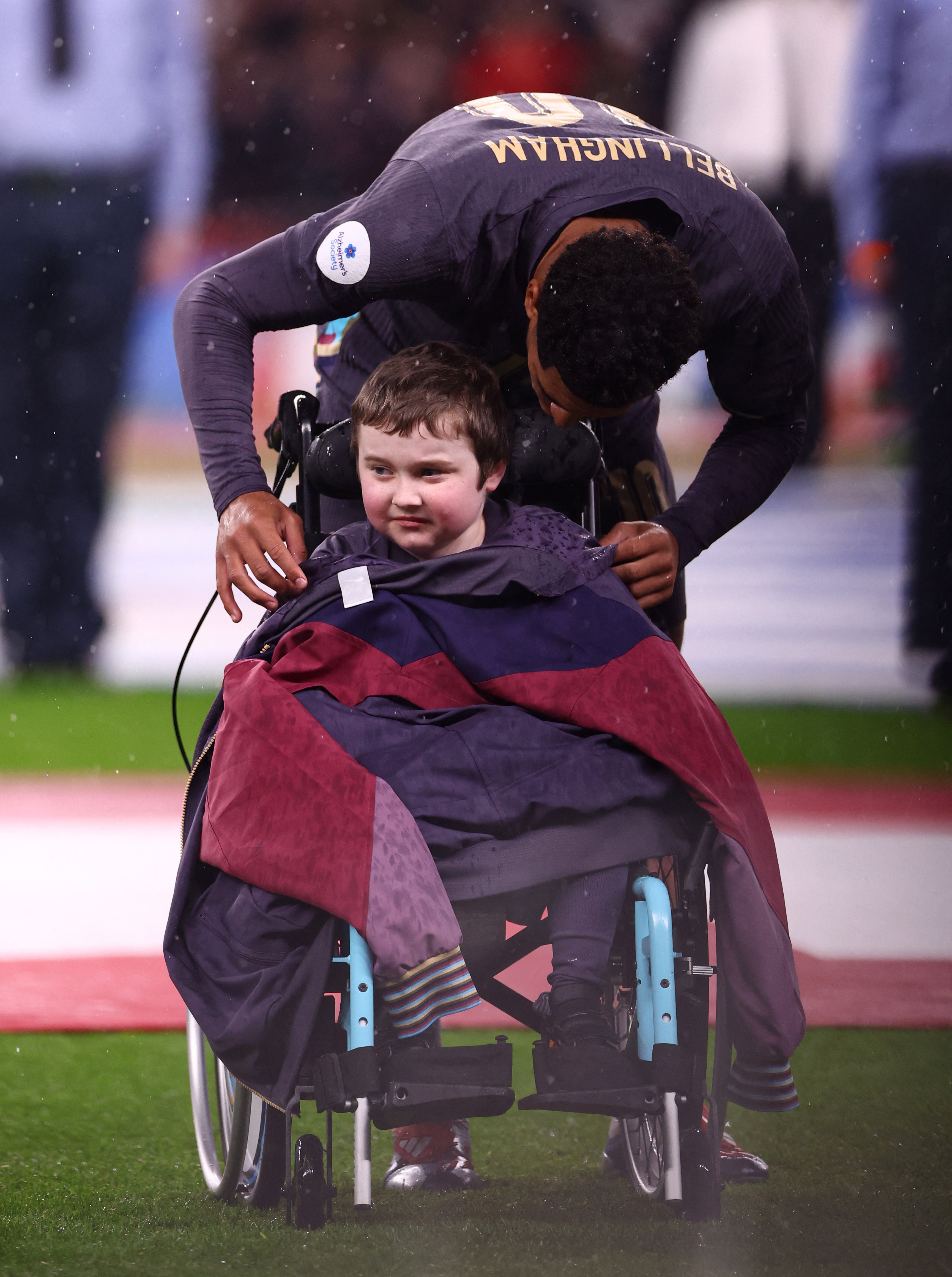 The England star gave the young fan his tracksuit top to keep him warm and dry