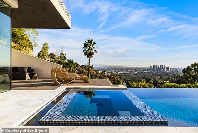 A hot tub is set within the pool area while allowing bathers to bask in the Southern California sunshine